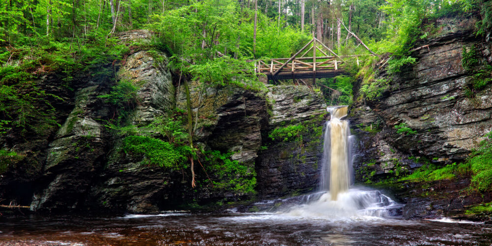 Deer Leap Falls Below A Wooden A Frame Bridge On Dingmans Creek At George W Childs Park, Delaware Water Gap National Recreation Area, Pennsylvania